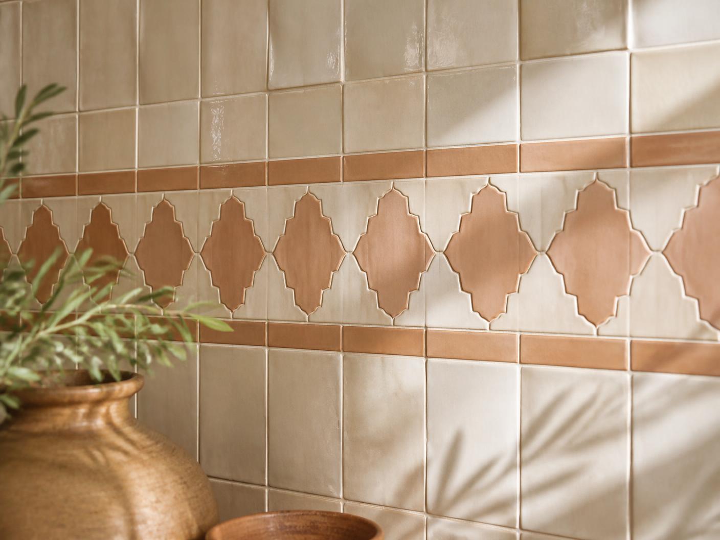 Handmade tile backsplash with decorative accent band and even grout lines